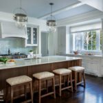 Kitchen with white cabinets and an oak island