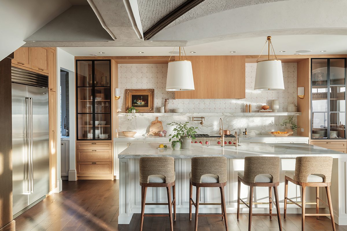 Luxury kitchen with light wood cabinetry and white stone countertops 
