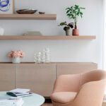 Minimalist and neutral seating area with a contemporary chair