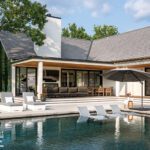 Elegant backyard with modern swimming pool, submerged lounge chairs, shaded patio, and black-framed glass doors connecting to the house.