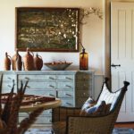 Inviting game room with a painted dresser, woven armchair, and backgammon board on a round table
