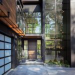 Contemporary home exterior featuring floor-to-ceiling glass windows and a wood-accented facade, designed by LDa Architecture.
