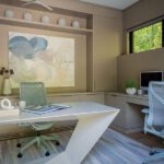 Minimalist home office with sculptural desk, soft neutral palette, and contemporary art, illuminated by natural light.