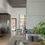Open-concept living space with modern fireplace, wood accents, and a view into the formal dining area framed by garden views.