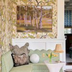 Custom green banquette with floral wallpaper and landscape painting