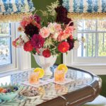 Vintage bar with glass top, bold florals, and colorful cocktails