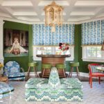Playful lounge with vintage bar, green stools, and eclectic furnishings