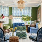 Eclectic lounge with blue velvet seating, patterned drapes, and bold textures