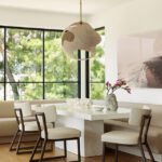 Cozy dining nook with a sculptural pendant light and built-in banquette seating.