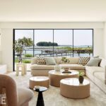 Light-filled living room with a sectional sofa and sweeping water views.