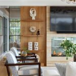 Cozy family room with fireplace, TV, and built-in wood shelving
