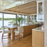 Bright waterfront kitchen with natural wood cabinetry and large island
