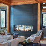 Sleek black metal fireplace anchors wood-accented living room