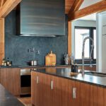 Modern kitchen with dark countertops and black stone backsplash