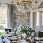 Sophisticated dining room with crystal chandelier and scenic wall mural by Erin Gates.