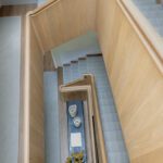 Bird’s-eye view of modern wood staircase with clean lines and sculptural geometry.