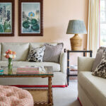 Cozy living room with neutral sofas, botanical artwork, and eclectic layered decor