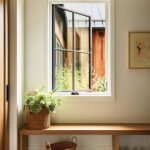 Mudroom with wood bench, woven baskets, and open window looking onto garden.