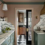 Pantry view with green cabinetry and black-and-white checkered tile flooring