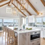 Bright kitchen with vaulted ceiling, wood beams, and large island