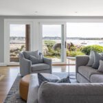 Coastal living room with fireplace and water views