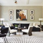 Contemporary living room with abstract artwork and neutral furnishings