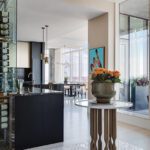 Open kitchen and dining area with floor-to-ceiling windows and city views.