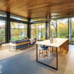 Open concept living and dining area with floor-to-ceiling windows