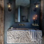 Dark and moody powder room with rough wood beams and a rugged